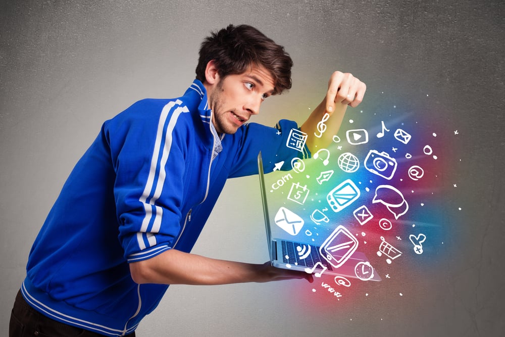 Casual young man holding laptop with colorful hand drawn multimedia symbols-2